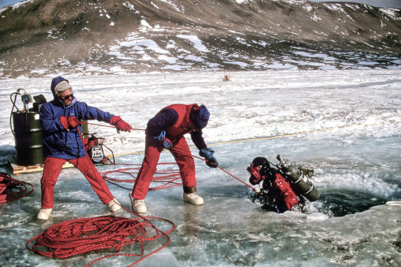 colleagues pulling Dale Andersen getting out of the icy lake