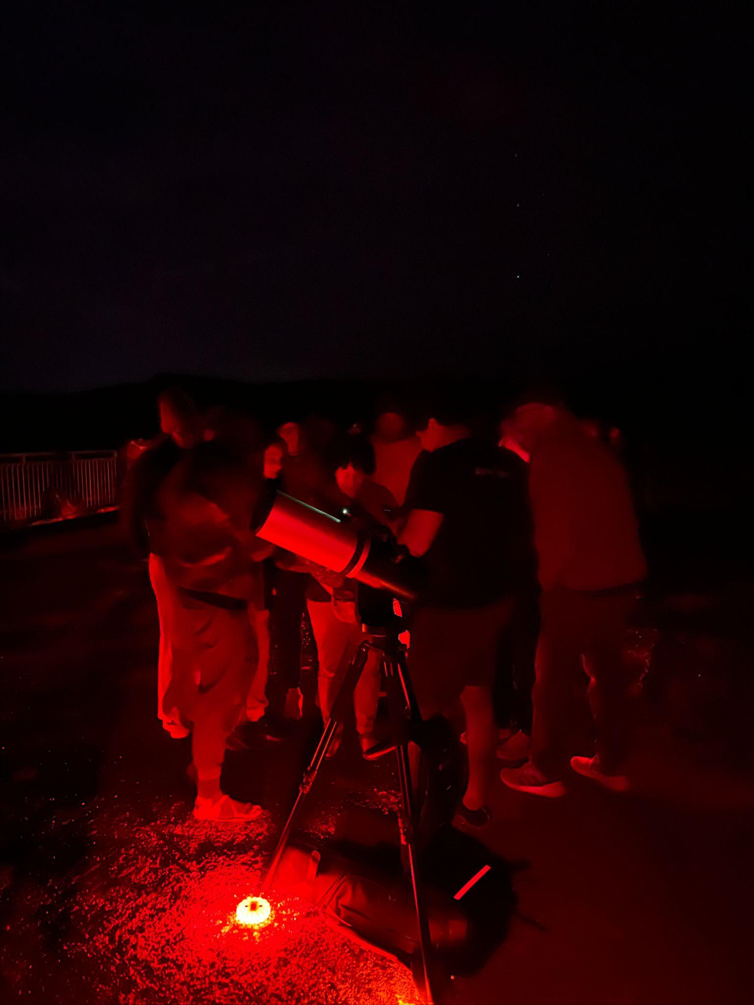 people gathering in the dark to look through the eVscope