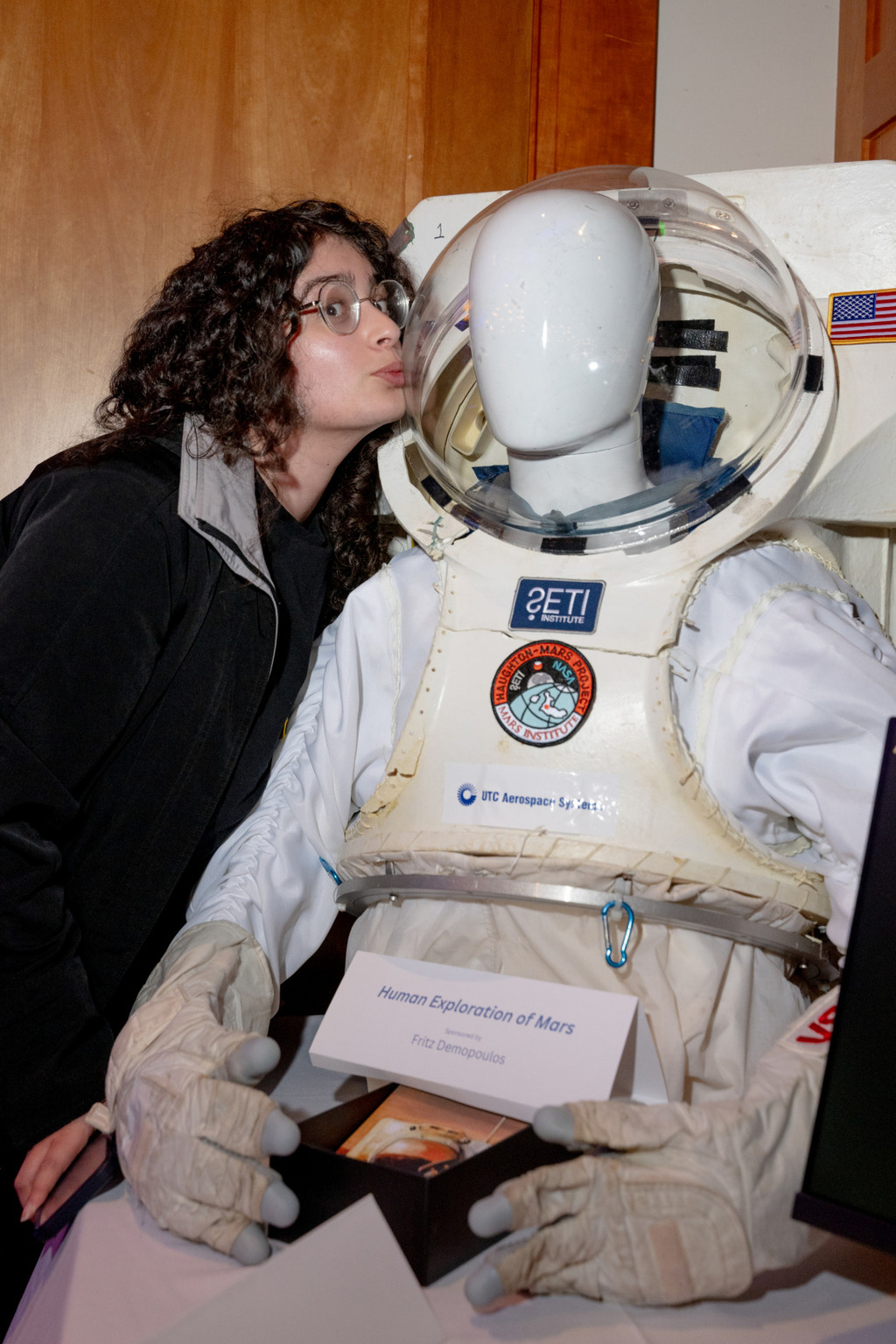 Susan Chaida kisses an astronaut helmet at the SETI party. | Source:Niki Williams for The Standard