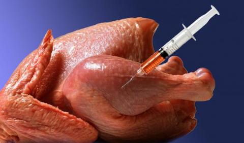 image of a raw chicken with a syringe 