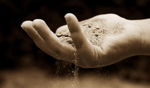 Image of a hand holding sand